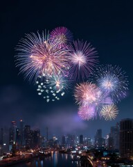 Fireworks over the City: Captivating spectacle of vibrant fireworks illuminating the night sky above a bustling cityscape. Exploding with color, they create a mesmerizing display of light and joy.