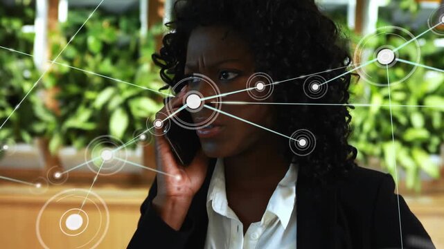 Animation of connected dots over angry african american businesswoman talking on smartphone