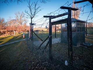 Cold War border zone replica in Petržalka, Bratislava, with barbed wire, warning sign, border gate and anti-tank obstacles marking the guarded East–West divide. © Marek