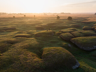 Aerial view of unique karst landscape in Estonia at sunrise featuring limestone formations and...