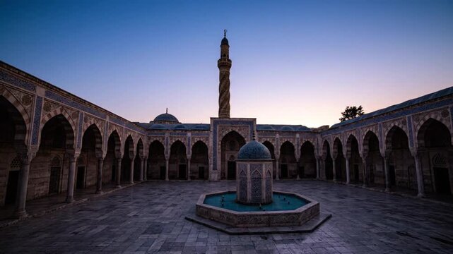 A grand stone courtyard with a central fountain surrounded by arched porticoes adorned with intricate patterns under a twilight sky