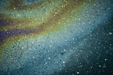 Colorful Oil Spill on a Surface With Bubbles and Texture in Natural Light During the Day