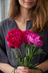 Woman with peony flower bouquet
