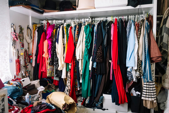 Messy home closet full of various clothes and accessories