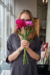 Woman with peony flower bouquet