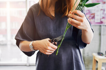Woman arranging vibrant, fresh flower bouquet