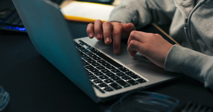 A child's hands move across the laptop touchpad, scrolling and clicking. He speaks softly to himself while researching and having a casual moment of self-expression.