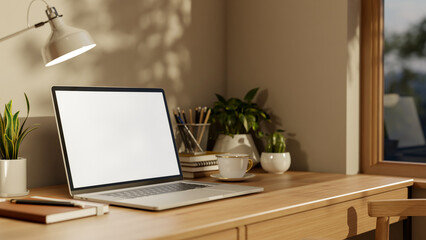 Fototapeta premium White screen laptop with coffee cup and book under lamp on wooden table aside window in living room.