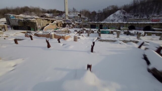 Aggressive fpv racing pass skimming snow covered industrial corridors in abandoned factory ruins, belgo factory shawinigan Montreal Canada