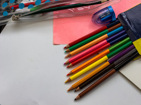 various stationery, colored pencils, pencil case with pens, diary, notebook with bookmarks, colored, white paper, tosser, creativity, school supplies, sketches of drawings