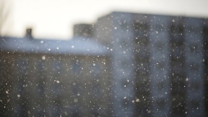 Snow falling on blurred city background snowfall falling snow blurry background