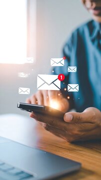 Man uses smartphone with overlaid mail icons indicating notification and new message