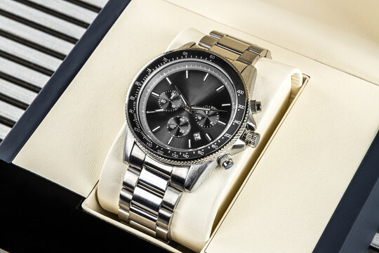 Modern men&rsquo;s wristwatch with black dial, gray stainless steel bracelet and elegant timeless design