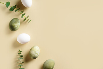 Easter concept background with brown eggs, eucalyptus leaves
