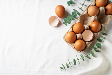 Easter concept background with brown eggs, eucalyptus leaves
