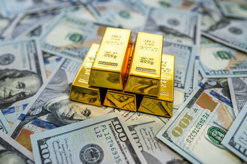 Pile of gold bars with dollar money representing inflation hedge and global market opportunity