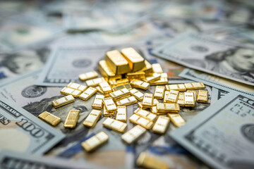 Dollar bills and gold bullion reflecting global economy, inflation, and trade rate fluctuations