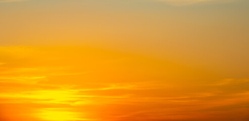 Dramatic golden sunset sky with vivid orange and purple clouds.beautiful twilight sky background with bright orange clouds during sunset.majestic evening sky with colorful cloudscape at golden hour.