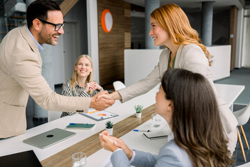 Handshake between business partners during successful office meeting