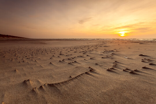 Sunset over a Sandy beach along the Curonian Spit by the Baltic Sea, Lithuania