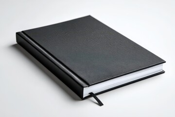 Closed black hardcover notebook on a white background with a blank cover for product mockup