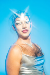 Portrait of a Latin Drag Queen in a Sleek Silver Outfit Under Studio Lighting