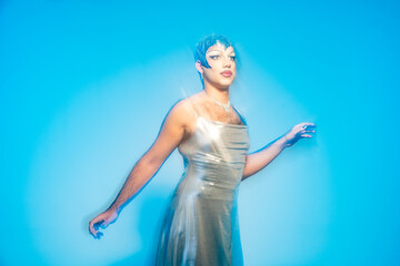 Latin Drag Queen Space Hero Showing Vibrant Energy With Light Streaks and Stars in Studio