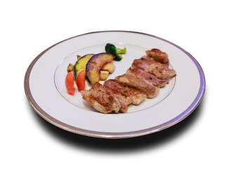 grilled meat or pork slice on dish with vegetables