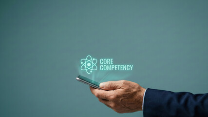 Business level planning concept core competency icon glow over mobile phone hand, abstract high tech communication idea for strategy focus success