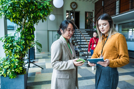 Teamwork and discussion in modern coworking office with digital devices