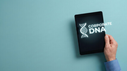 Business high level planning concept for corporate dna on digital tablet screen with hand holding device against blue background