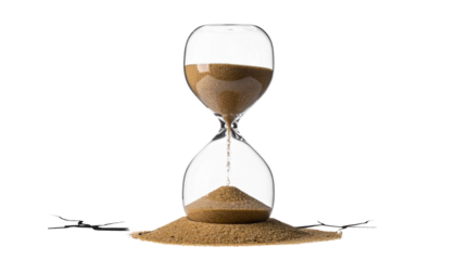 A classic hourglass with sand flowing against a black background