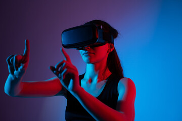 Woman in virtual reality headset controlling digital interface with dual finger gestures