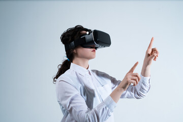 Woman navigating digital interface using virtual reality headset and hand gestures in futuristic technology environment