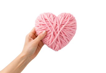 Hand holding pink yarn wrapped heart shape craft, isolated on a transparent background