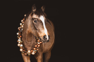 Pferd mit Weihnachtskugelgirlande