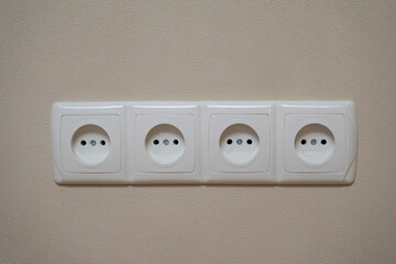 Close-up of european electrical sockets on the wall in the room.