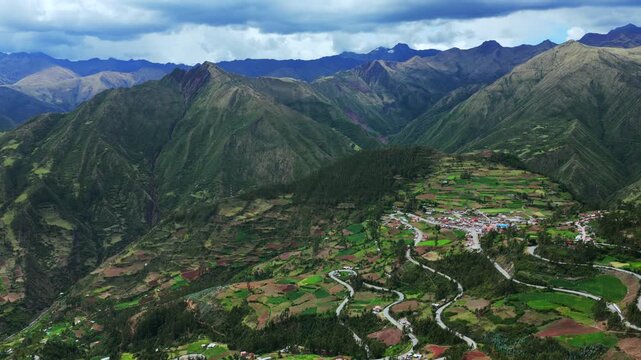 Peruvian Andes mountain range Limatambo Heertahuayco mount Humantay Salkantay Peru aerial drone highlands avocado farm crops Cusco region warm climate Soray rainy season clouds backwards up motion