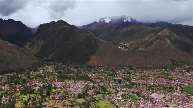 Chic&oacute;n town Peru Per&uacute; aerial drone Peruvian Andes canyon rainy season cloudy Mount Patacancha Cuncani Pumahuanca glacier Sacred Valley Quelccaya Urubamba range cusco region circle right motion