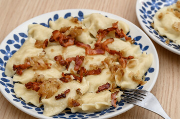 Hot Polish pierogi with meat and lard on a plate