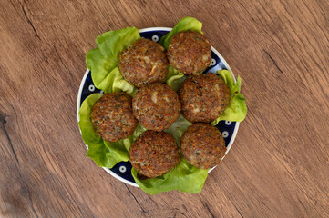 Baked minced meatballs, a full plate on the table