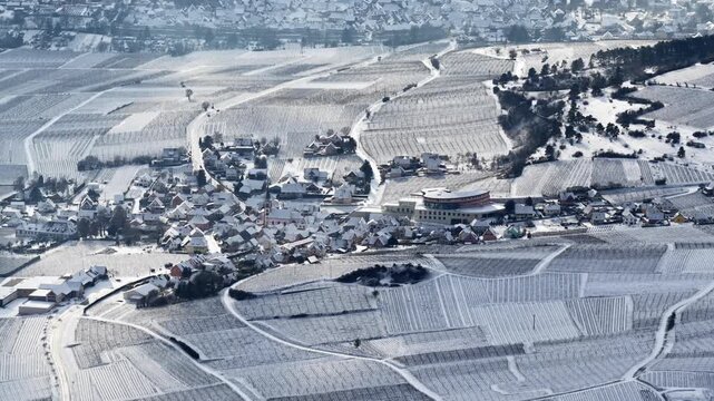 Aerial view of snow-covered vineyards creating stark white patterns contrasting with the dark outlines of the fields, Orschwiller, Grand Est, France.
