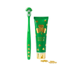 Green toothbrush and "Lucky Smile" toothpaste with golden shamrocks, St. Patrick's Day dental care concept isolated on transparent or white background, png
