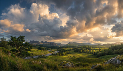 Fototapeta premium Sunset over green mountains with clouds and a scenic meadow view