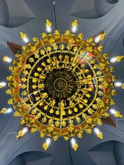 Ornate chandelier hanging inside Panagia Eleousa Church (&Pi;&alpha;&nu;&alpha;&gamma;ί&alpha; &Epsilon;&lambda;&epsilon;&omicron;ύ&sigma;&alpha;) in Agros village, Cyprus, highlighting intricate metalwork, warm lighting, and traditional Orthodox interior decor