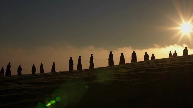Silhouetted worshippers gather for an Easter sunrise service as the sun breaks the horizon.