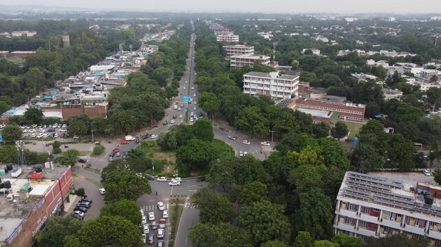 Chandigarh drone video - Aerial drone footage of Chandigarh city showcasing its modern urban planning, roundabout, wide roads, green spaces, and iconic architecture. Chandigarh roundabout drone view.