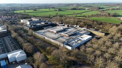 Aerial drone view of huge data Center, AI and Quantum cloud storage IT information systems and cooling units turbines. Sunny day in Royal Leamington Spa, United Kingdom 