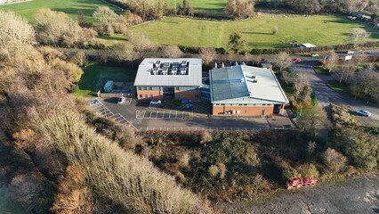 Aerial drone view of state of the art data center, AI and quantum cloud storage IT infrastructure, cooling fans and turbines. Sunny day near Redditch, United Kingdom.