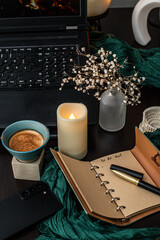 Cozy workspace with to-do list, coffee and candles &ndash; planning and mindfulness concept